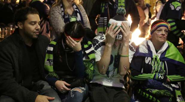 Seattle Seahawks fans sit in disappointment after their team lost the Super Bowl XLIX to the New England Patriots, Feb. 1, 2015.